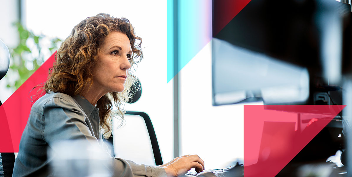 a woman is sitting in front of a computer monitor