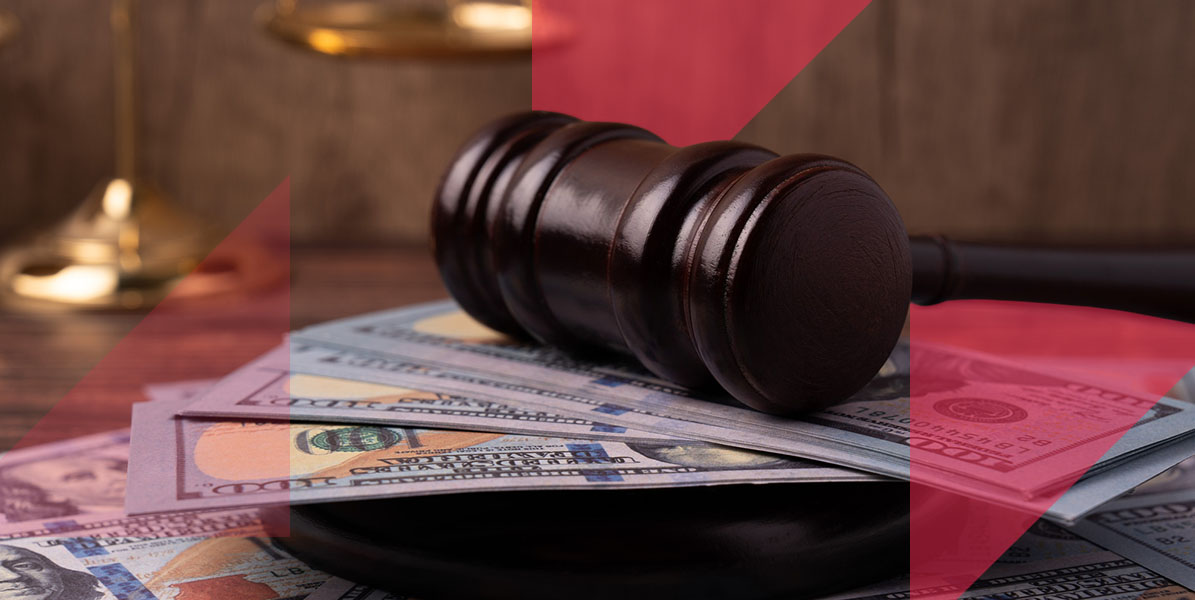 a judge 's gavel is sitting on top of a pile of money